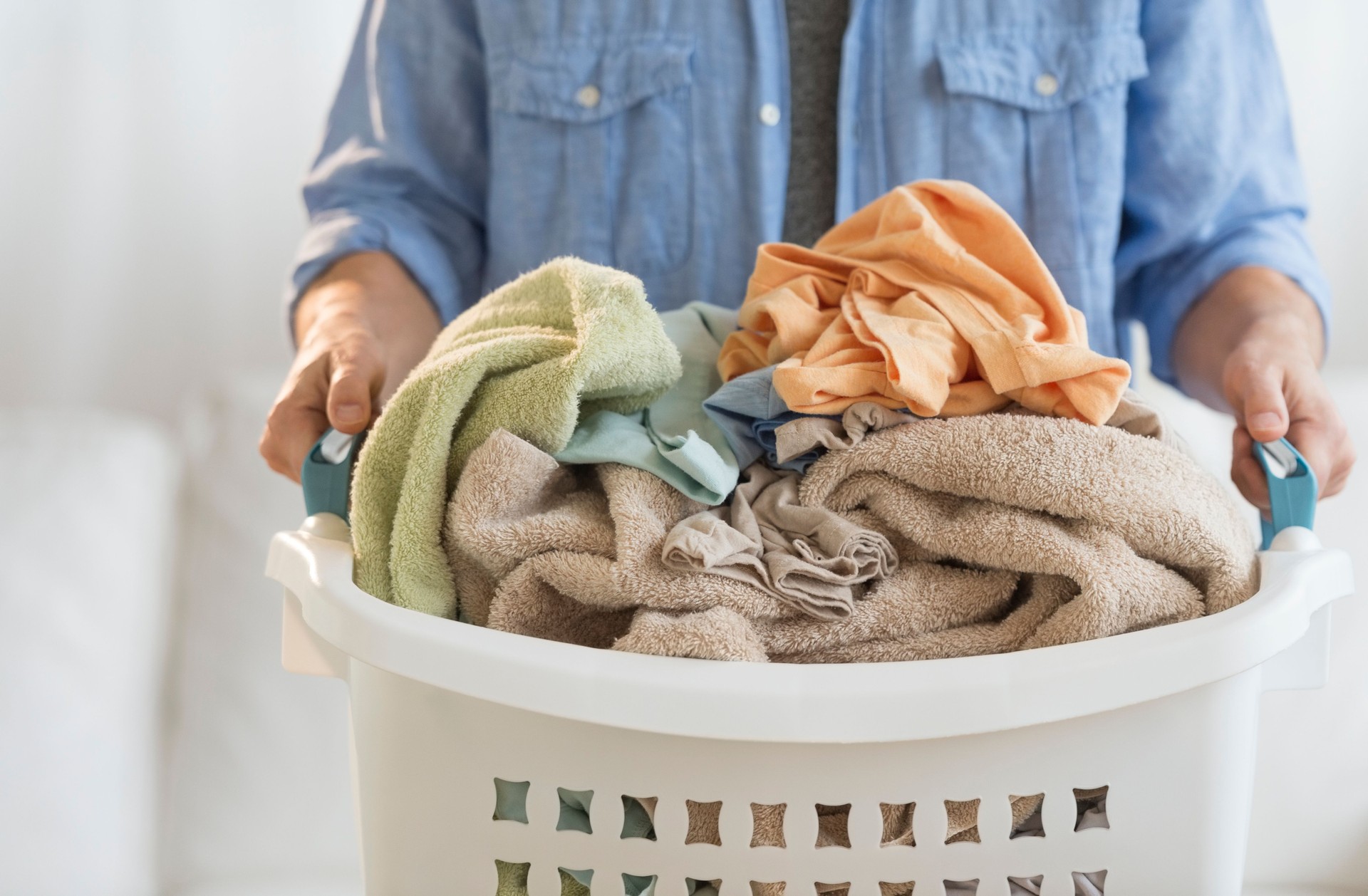 Man Holding Laundry Basket At Home